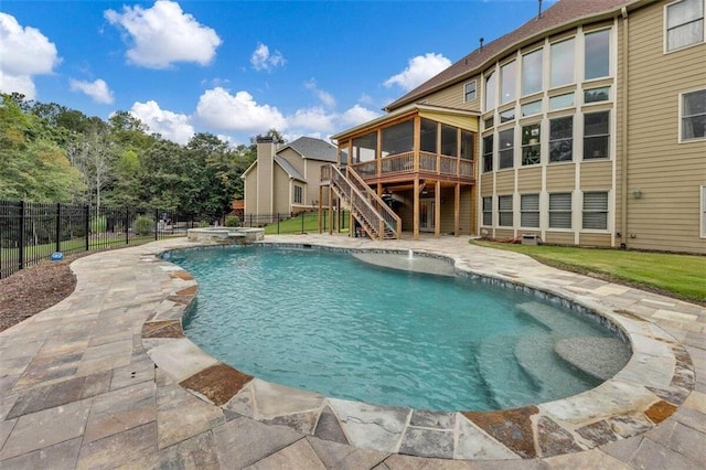 view of swimming pool with a patio area, a sunroom, and a wooden deck