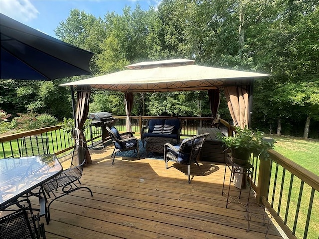 wooden deck featuring grilling area, outdoor lounge area, a lawn, and a gazebo