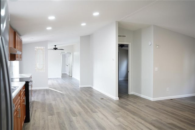 kitchen with light wood-type flooring, vaulted ceiling, black electric range oven, and ceiling fan