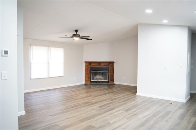 unfurnished living room with ceiling fan and light hardwood / wood-style flooring