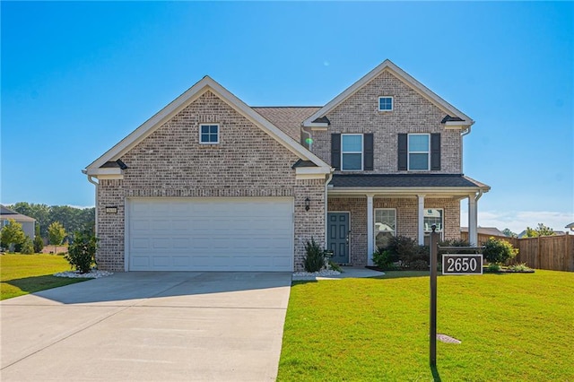 view of front of home with a porch, a front yard, and a garage