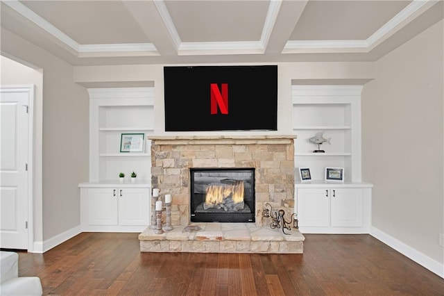 unfurnished living room with crown molding, a stone fireplace, built in features, and dark hardwood / wood-style flooring