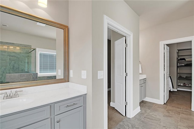 bathroom with vanity and a shower with shower door