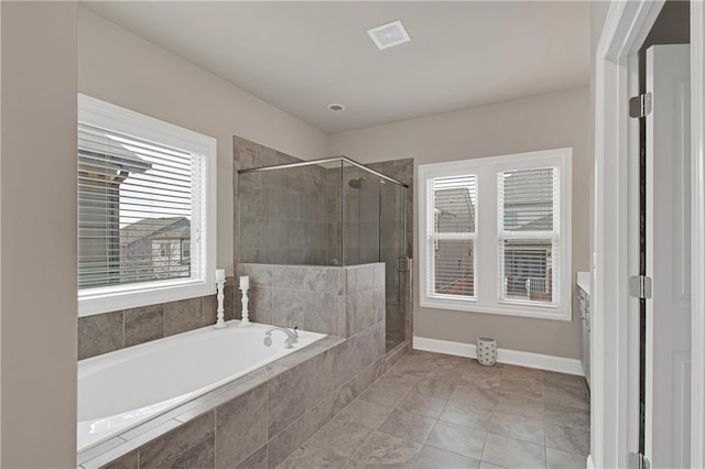 bathroom with vanity, a wealth of natural light, and plus walk in shower