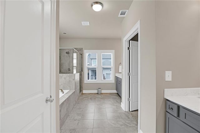 bathroom featuring vanity, independent shower and bath, and tile patterned flooring