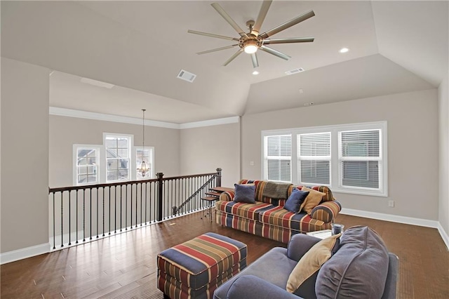 living room with dark hardwood / wood-style flooring, vaulted ceiling, ornamental molding, and ceiling fan