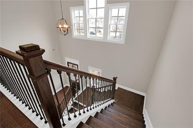 stairway featuring a chandelier and hardwood / wood-style floors