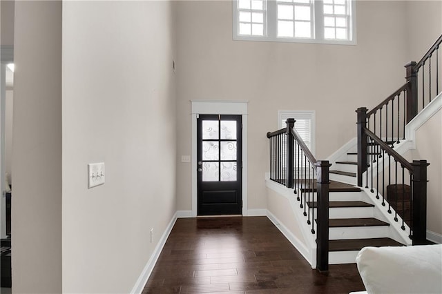 foyer featuring dark hardwood / wood-style flooring and a high ceiling