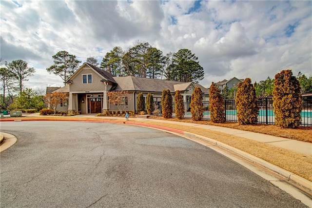 view of front of house with a swimming pool