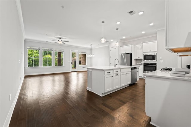 240 Walker Ave, Roswell, GA 30076 - kitchen featuring stainless steel appliances, a sink, crown molding, open floor plan, and baseboards