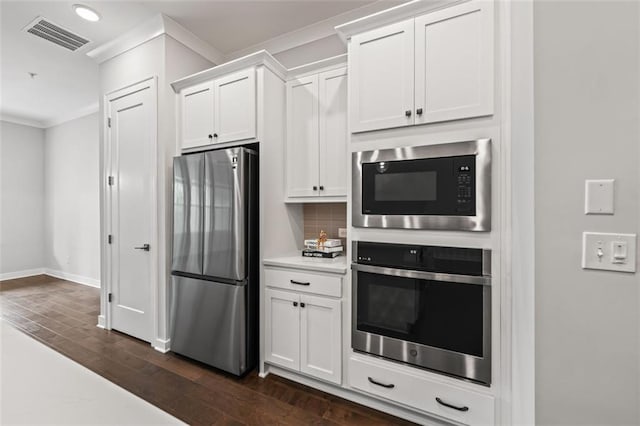 240 Walker Ave, Roswell, GA 30076 - kitchen with stainless steel appliances, ornamental molding, tasteful backsplash, light countertops, and white cabinetry