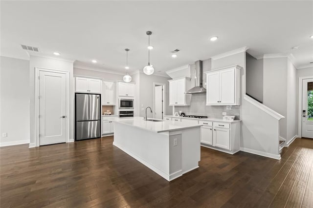 240 Walker Ave, Roswell, GA 30076 - kitchen featuring appliances with stainless steel finishes, a sink, crown molding, wall chimney range hood, and backsplash