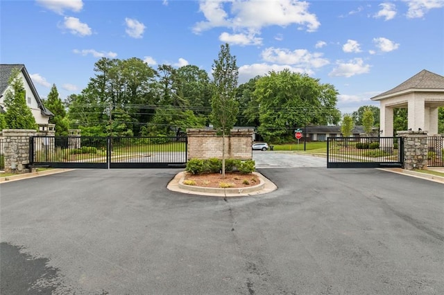 240 Walker Ave, Roswell, GA 30076 - view of asphalt street with a gate, a gated entry, and curbs
