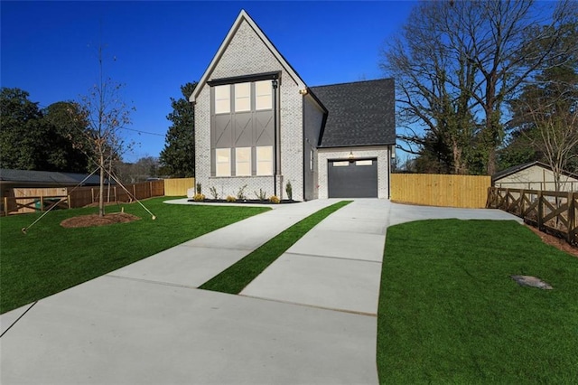 view of front of house featuring a garage and a front lawn