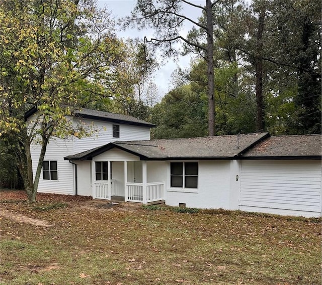 exterior space featuring a porch and a lawn