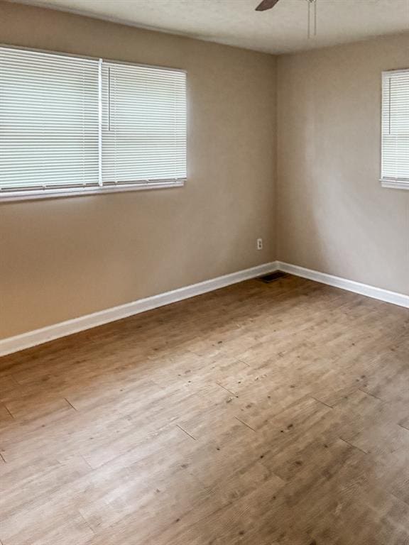 spare room with ceiling fan and light hardwood / wood-style flooring