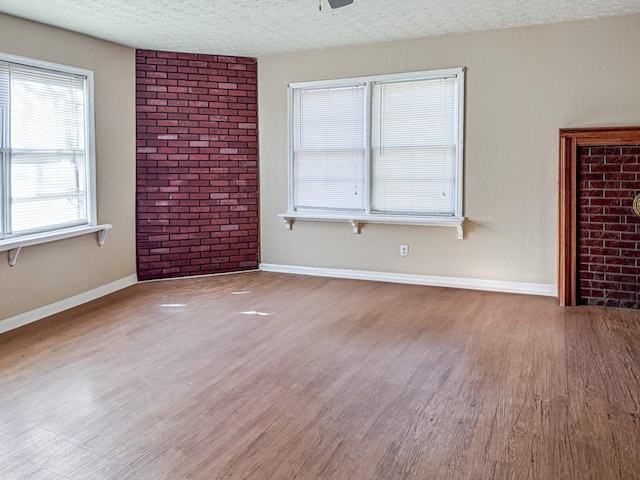 interior space with wood-type flooring, a textured ceiling, and ceiling fan