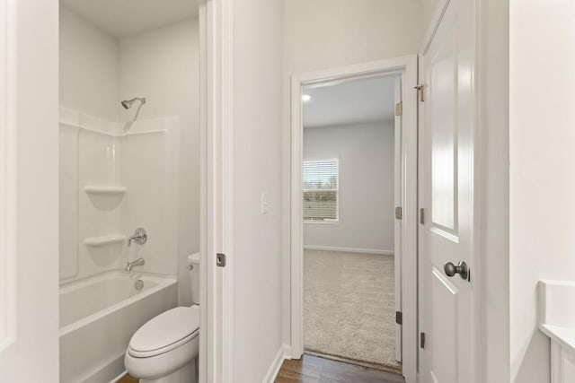 bathroom with toilet, shower / bath combination, baseboards, and vanity