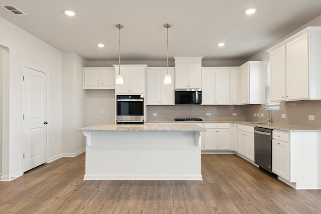 kitchen featuring appliances with stainless steel finishes, a center island, and white cabinets