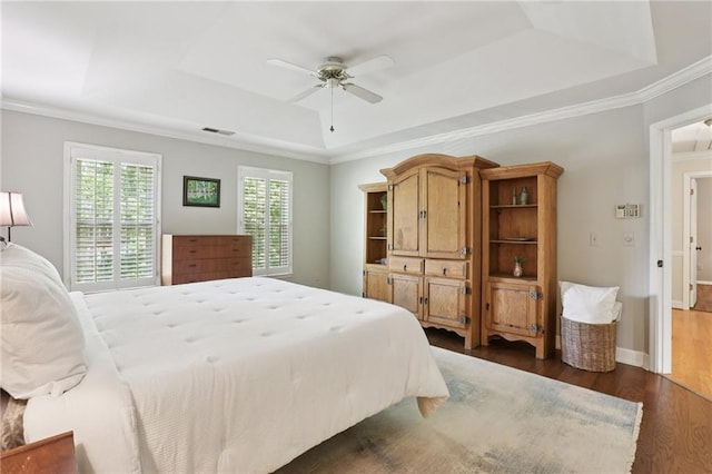 2819 Saddlebrook Way NW, Marietta, GA 30064 - bedroom featuring a tray ceiling, dark wood-type flooring, ornamental molding, a ceiling fan, and baseboards
