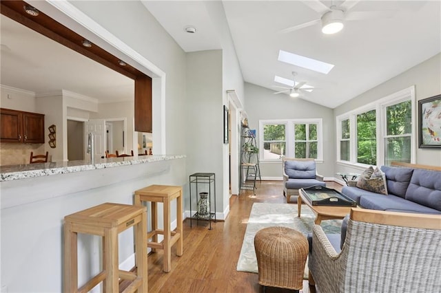 2819 Saddlebrook Way NW, Marietta, GA 30064 - living area featuring ceiling fan, a skylight, light wood finished floors, lofted ceiling, and baseboards