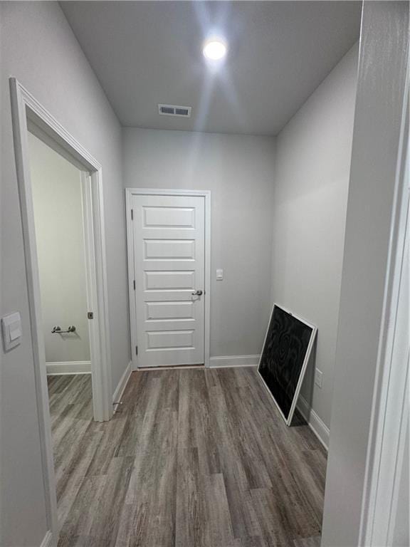 corridor with wood-type flooring