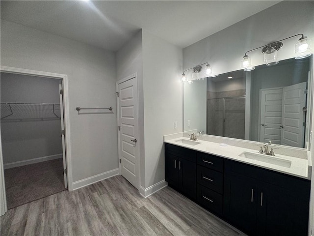 bathroom with vanity, an enclosed shower, and hardwood / wood-style flooring