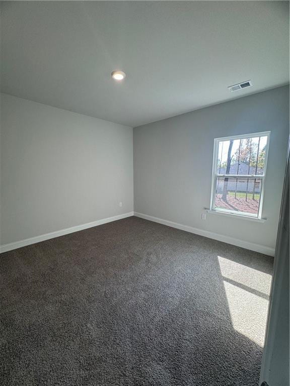 empty room featuring dark colored carpet