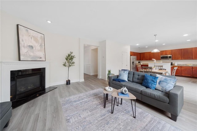 6018 Oakdale Rd SE, Mableton, GA 30126 - living area with light wood-type flooring, recessed lighting, and a glass covered fireplace