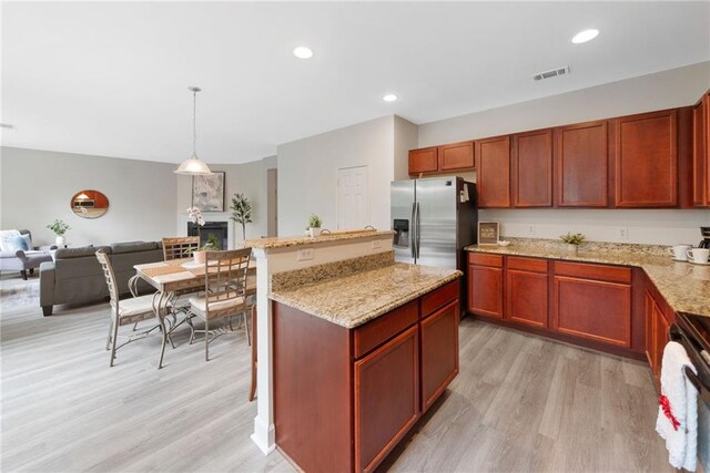 6018 Oakdale Rd SE, Mableton, GA 30126 - kitchen with stainless steel fridge with ice dispenser, light wood-style flooring, stove, light stone countertops, and recessed lighting
