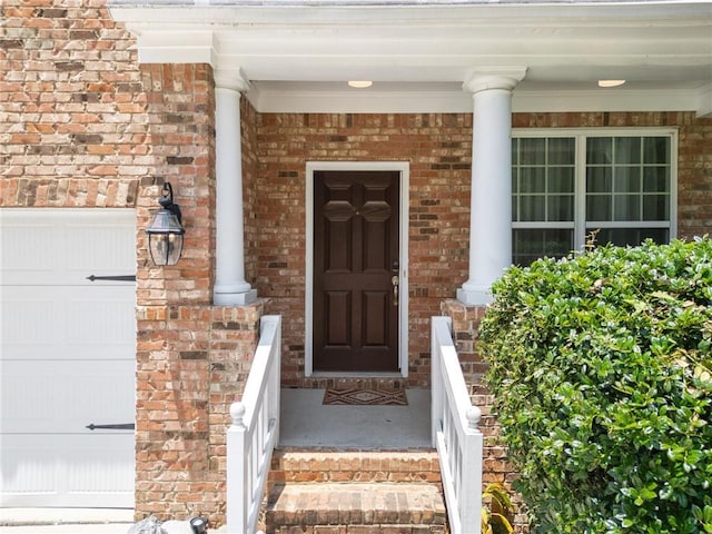 6018 Oakdale Rd SE, Mableton, GA 30126 - entrance to property featuring a porch, brick siding, and a garage