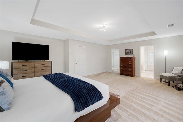 6018 Oakdale Rd SE, Mableton, GA 30126 - carpeted bedroom featuring a raised ceiling and connected bathroom