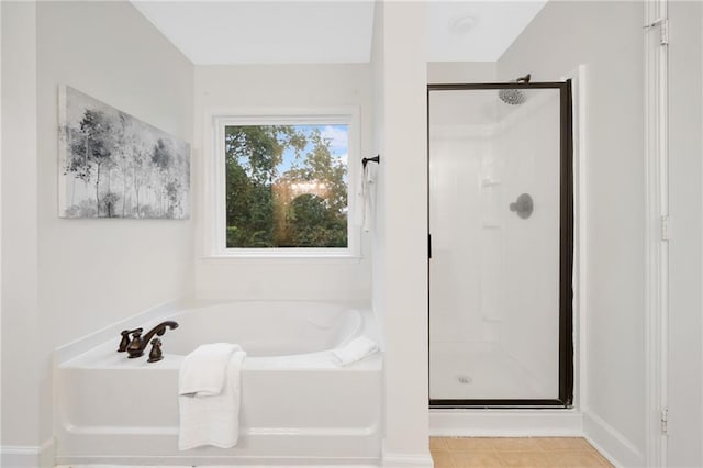 6018 Oakdale Rd SE, Mableton, GA 30126 - full bathroom with a stall shower, a bath, and tile patterned flooring