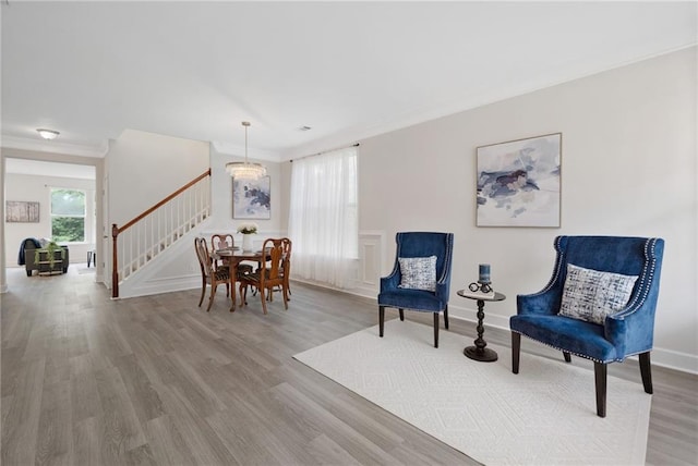 6018 Oakdale Rd SE, Mableton, GA 30126 - living area with stairs, light wood-type flooring, ornamental molding, and a chandelier