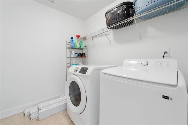 6018 Oakdale Rd SE, Mableton, GA 30126 - laundry area featuring washer and clothes dryer and light tile patterned floors