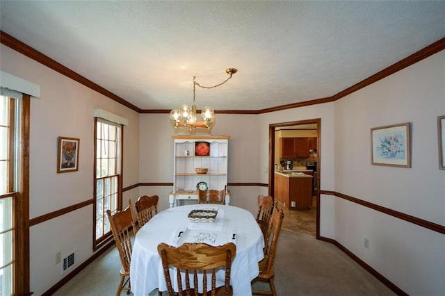 118 Heritage Way, Peachtree City, GA 30269 - carpeted dining space featuring a chandelier, baseboards, and ornamental molding