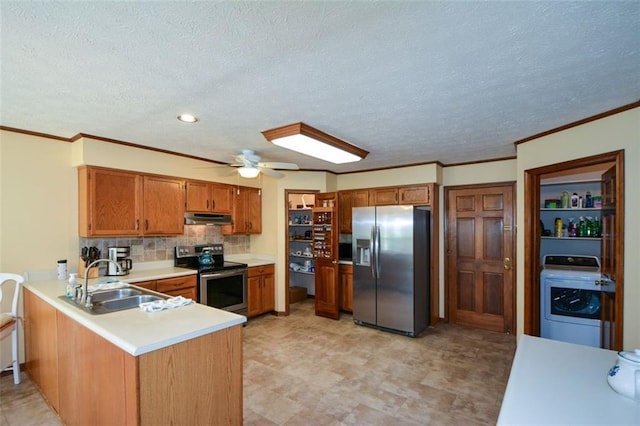 118 Heritage Way, Peachtree City, GA 30269 - kitchen featuring appliances with stainless steel finishes, washer / dryer, a sink, under cabinet range hood, and a peninsula