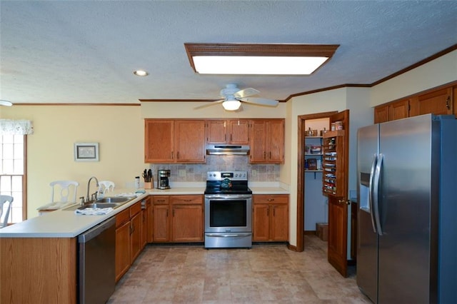 118 Heritage Way, Peachtree City, GA 30269 - kitchen featuring stainless steel appliances, under cabinet range hood, a sink, a peninsula, and brown cabinets
