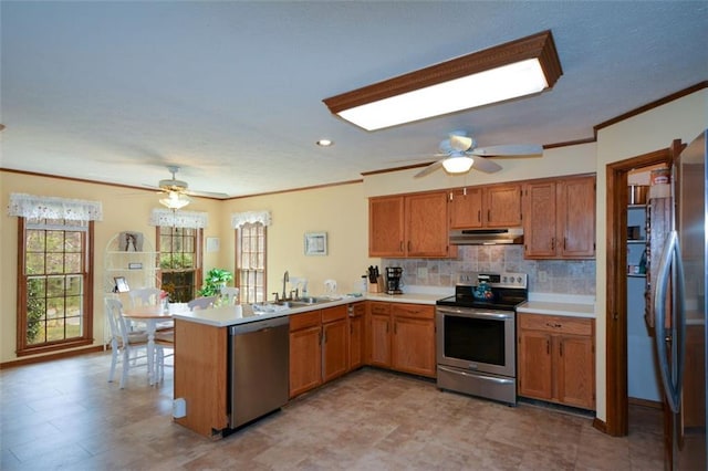 118 Heritage Way, Peachtree City, GA 30269 - kitchen with stainless steel appliances, a peninsula, under cabinet range hood, a ceiling fan, and crown molding