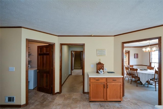118 Heritage Way, Peachtree City, GA 30269 - kitchen featuring washer / dryer, a chandelier, light countertops, a textured ceiling, and baseboards