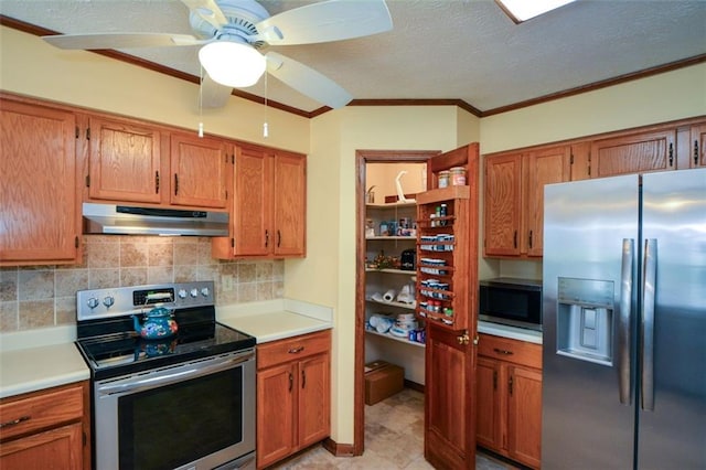 118 Heritage Way, Peachtree City, GA 30269 - kitchen featuring appliances with stainless steel finishes, under cabinet range hood, light countertops, decorative backsplash, and ornamental molding