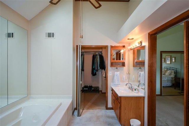 118 Heritage Way, Peachtree City, GA 30269 - bathroom featuring vanity, vaulted ceiling, a garden tub, ceiling fan, and a walk in closet