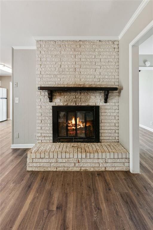 unfurnished living room featuring baseboards, ceiling fan, vaulted ceiling with beams, and wood finished floors