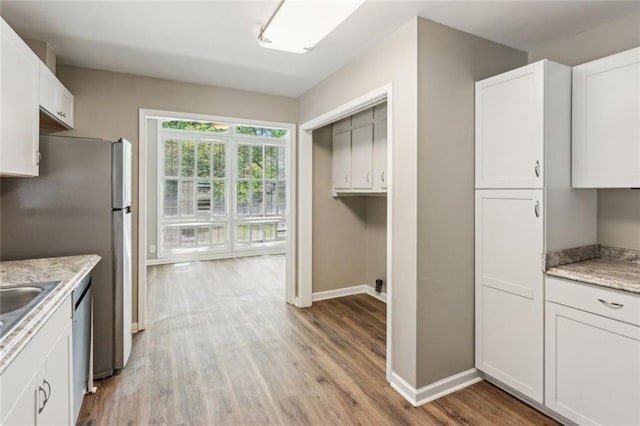 kitchen with a sink, white cabinetry, and appliances with stainless steel finishes