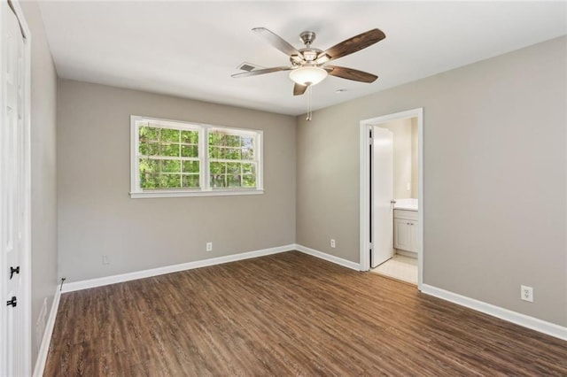 empty room featuring baseboards, ceiling fan, and wood finished floors