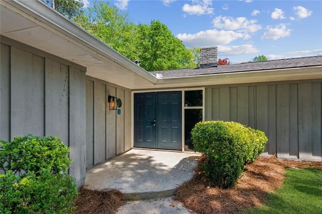view of front of house with fence, brick siding, a front yard, a chimney, and concrete driveway