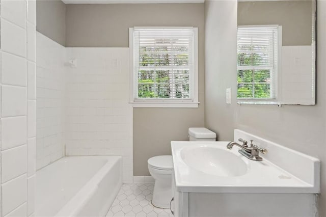 empty room featuring a wealth of natural light, lofted ceiling, and wood finished floors