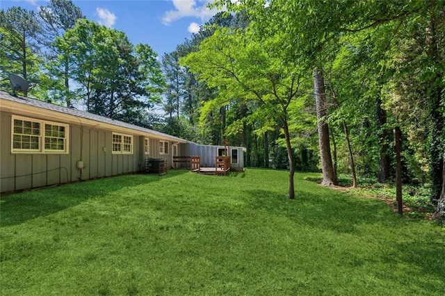 rear view of property featuring a patio, a fenced backyard, board and batten siding, and a yard