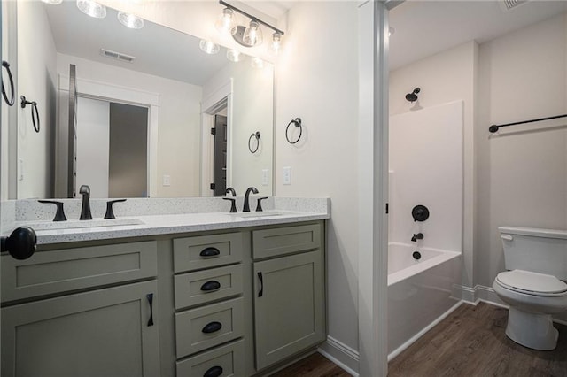 full bathroom with shower / bathtub combination, vanity, toilet, and hardwood / wood-style floors