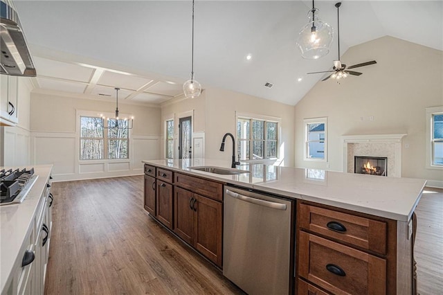 kitchen featuring sink, light stone counters, appliances with stainless steel finishes, dark hardwood / wood-style floors, and range hood